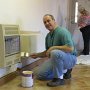 Chris painting around the heater.